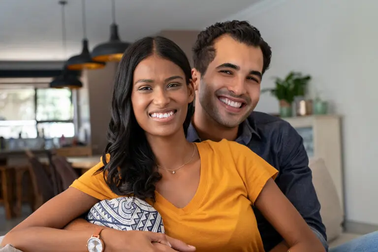 Young married couple sitting on a couch